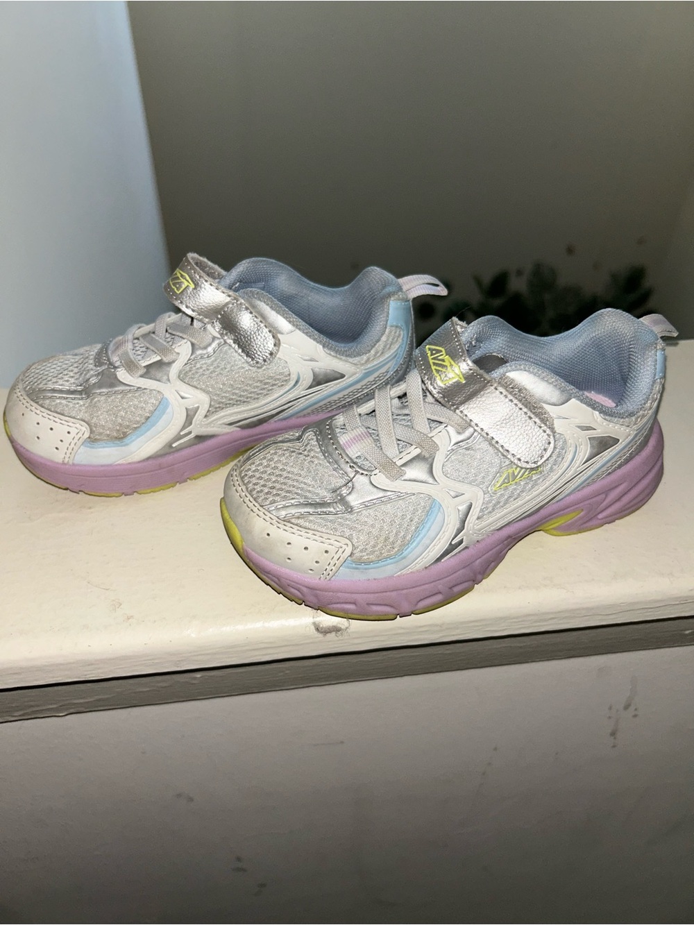 Nike Kids White Sneakers with Pastel Purple and Light Blue Accents